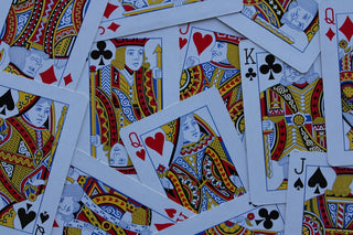 Scattered playing cards with kings, queens, and jacks.