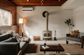 Cozy living room with wood stove and sofa