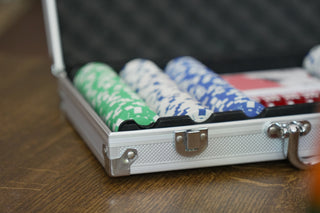Poker chips in an open silver case.